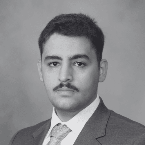 Black and white professional headshot of Ibrahem Albalkhi, a SovDoc leadership team member, wearing a suit and tie against a neutral background.