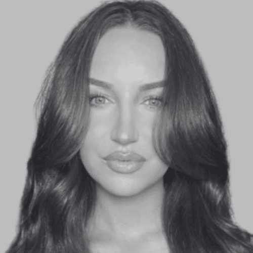 Black and white professional headshot of Gabby Boeger, a SovDoc leadership team member, with long wavy hair against a neutral background.