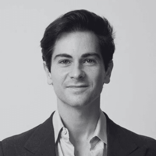 Black and white professional headshot of a SovDoc leadership team member wearing a suit, with a neutral background.
