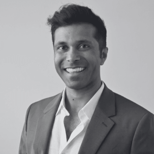 Black and white professional headshot of Rohan Joshi, a member of the SovDoc leadership team, wearing a suit and smiling against a neutral background.