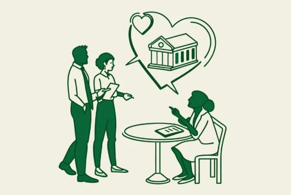 SovDoc healthcare M&A advisors discussing cardiology practice mergers and acquisitions, represented by professionals collaborating around a table with a heart symbol and building merger illustration