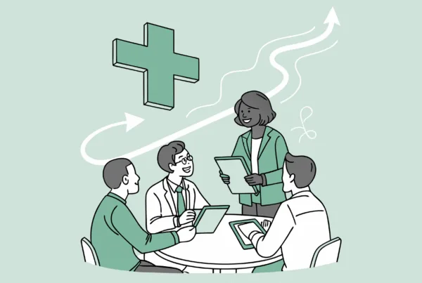 SovDoc healthcare M&A advisors collaborating around a table with hospice care symbolism, discussing auditing best practices for medical practice mergers and acquisitions in the hospice sector.