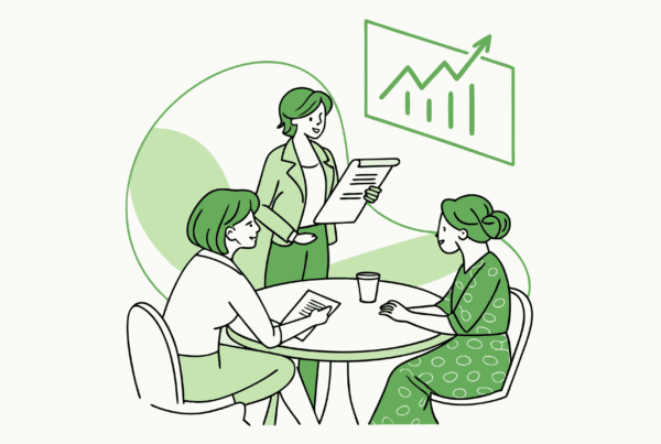 SovDoc healthcare M&A advisors discussing memory care center acquisition strategies around a conference table with financial growth projections, illustrating professional consultation for medical practice mergers in the senior care sector.