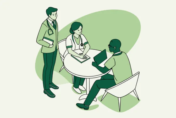 Business professionals and healthcare provider discussing palliative care practice mergers and acquisitions around a digital projection - SovDoc healthcare M&A advisory services supporting medical practice transitions.