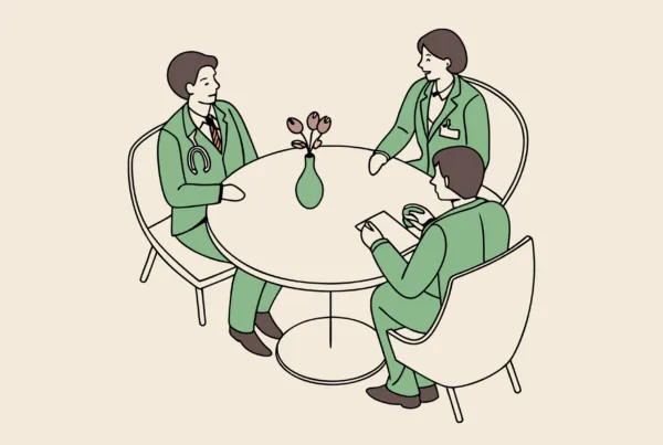 Professional roundtable discussion between legal and medical advisors discussing pediatric physical therapy practice mergers and acquisitions, with a model facility at center - SovDoc healthcare M&A consultation representing medical practice consolidation expertise.