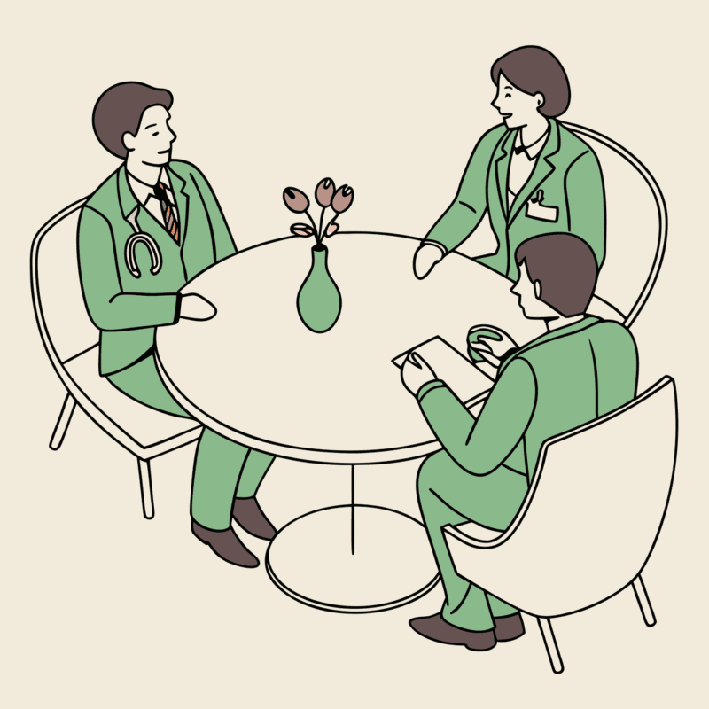 Professional roundtable discussion between legal and medical advisors discussing pediatric physical therapy practice mergers and acquisitions, with a model facility at center - SovDoc healthcare M&A consultation representing medical practice consolidation expertise.