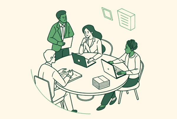 SovDoc healthcare consultants discussing hospice care mergers and acquisitions around a conference table, representing collaborative strategic planning in healthcare M&A.